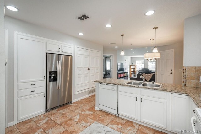 12281 E Tennessee Dr Unit 303, Aurora, CO 80012 - kitchen with stainless steel refrigerator with ice dispenser, white dishwasher, a peninsula, white cabinetry, and recessed lighting
