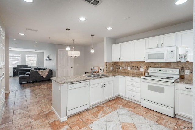 12281 E Tennessee Dr Unit 303, Aurora, CO 80012 - kitchen featuring white appliances, backsplash, white cabinetry, a peninsula, and recessed lighting