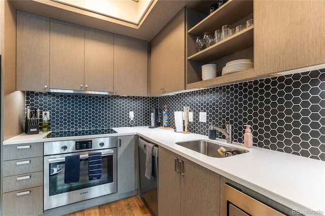 kitchen featuring stainless steel appliances, sink, and backsplash