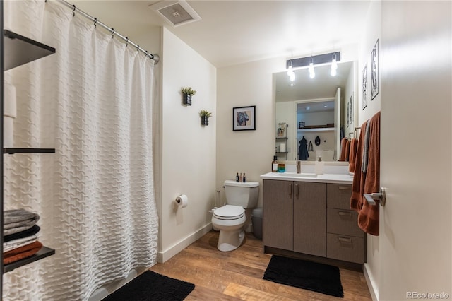 bathroom with vanity, hardwood / wood-style floors, and toilet