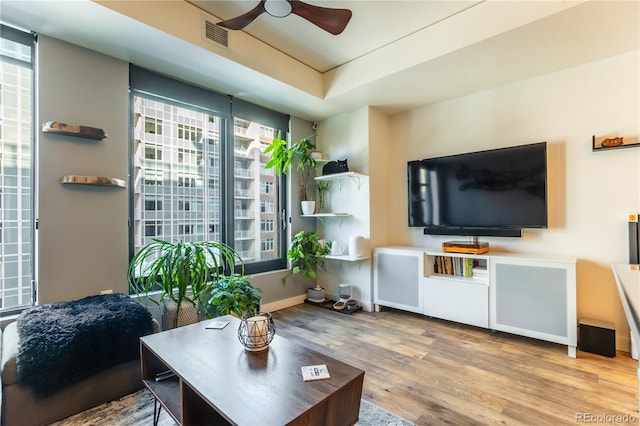 living room with hardwood / wood-style flooring and ceiling fan