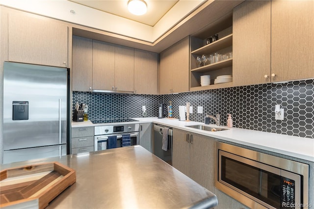 kitchen featuring sink, built in appliances, light brown cabinetry, and decorative backsplash