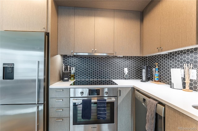 kitchen featuring stainless steel appliances and backsplash