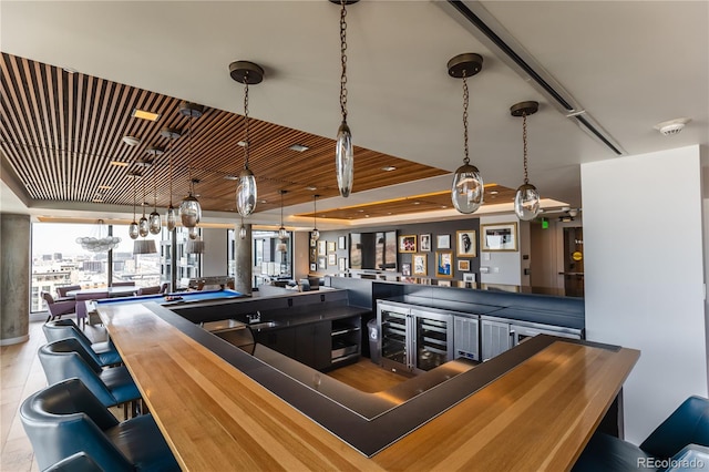 bar with billiards and decorative light fixtures