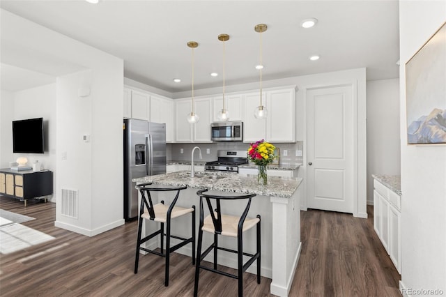 1678 Wright Aly, Erie, CO 80516 - kitchen featuring stainless steel appliances, a sink, dark wood-type flooring, white cabinets, and light stone countertops