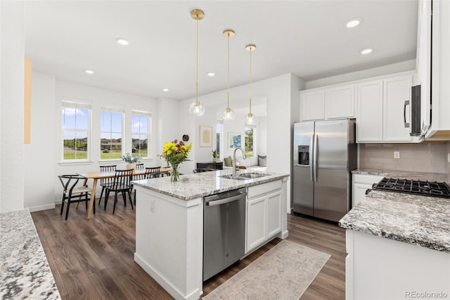 1678 Wright Aly, Erie, CO 80516 - kitchen with stainless steel appliances, a sink, a kitchen island with sink, dark wood-type flooring, and recessed lighting