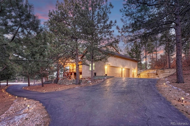 view of front of house with aphalt driveway and an attached garage