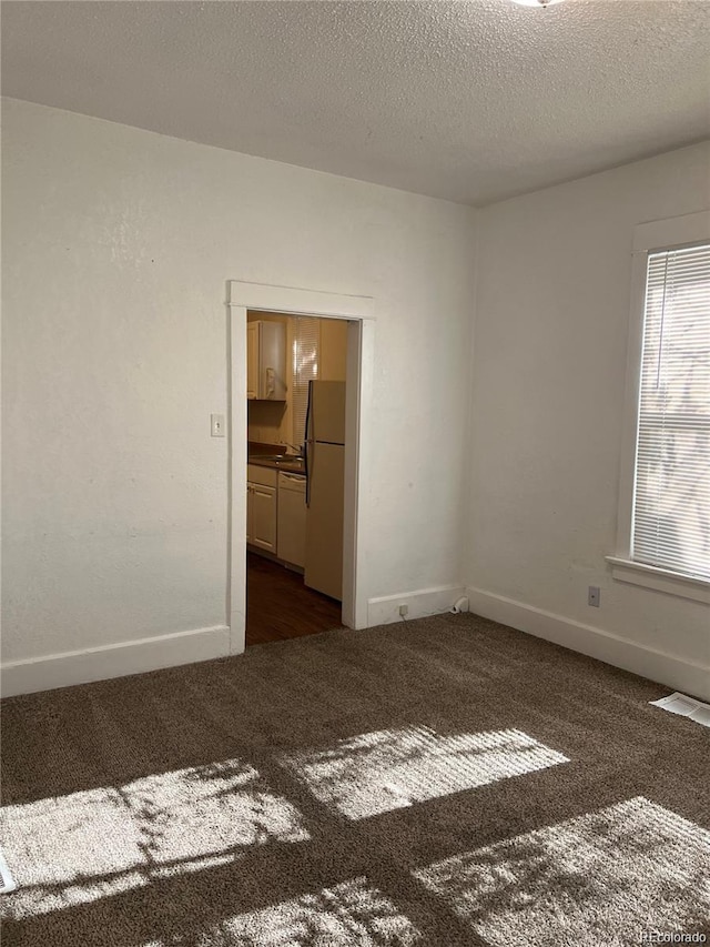 1964 Galena St, Aurora, CO 80010 - empty room featuring dark carpet and a textured ceiling
