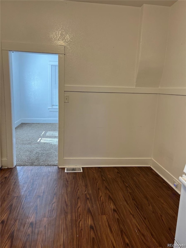 spare room featuring dark hardwood / wood-style floors