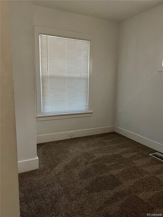 1964 Galena St, Aurora, CO 80010 - empty room featuring dark carpet and baseboards