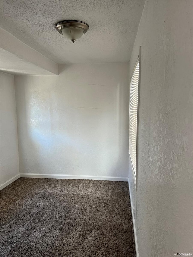 empty room featuring carpet floors and a textured ceiling