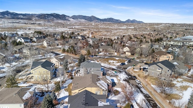 snowy aerial view featuring a mountain view