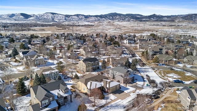 snowy aerial view with a mountain view