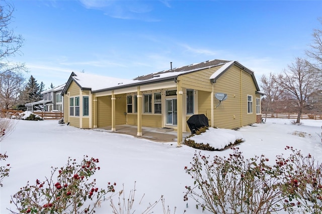 view of snow covered rear of property