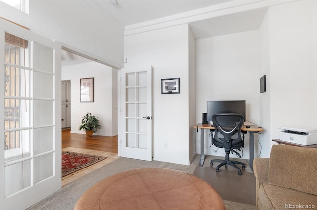 office space featuring french doors, a healthy amount of sunlight, and light hardwood / wood-style flooring