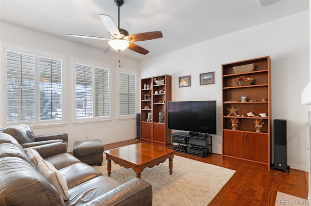 living room featuring dark hardwood / wood-style flooring and ceiling fan