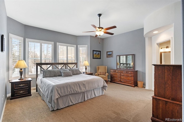 bedroom with ceiling fan and light colored carpet