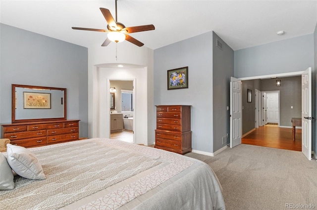 carpeted bedroom featuring ensuite bath and ceiling fan