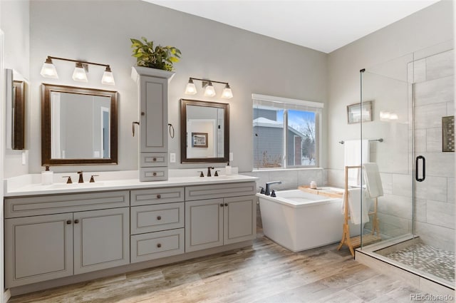 bathroom featuring vanity, shower with separate bathtub, and wood-type flooring