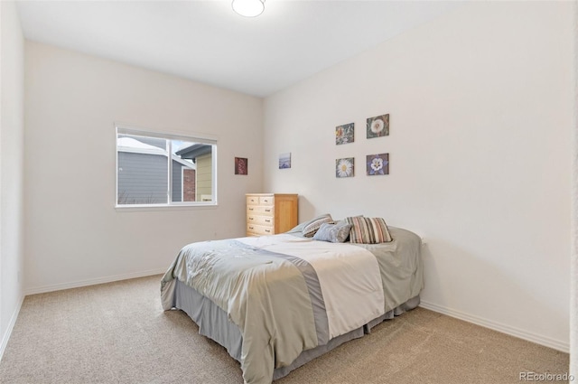 bedroom with light colored carpet