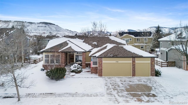 view of front facade featuring a mountain view and a garage