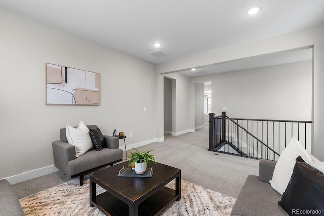 carpeted living room featuring recessed lighting, visible vents, and baseboards