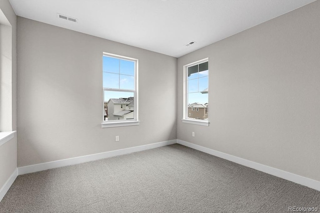 unfurnished room with carpet floors and baseboards