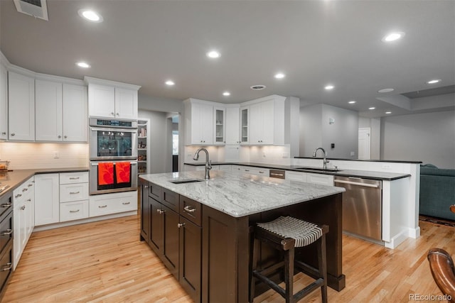 5164 E Princeton Ave, Cherry Hills Village, CO 80113 - kitchen with visible vents, a sink, a peninsula, and stainless steel appliances