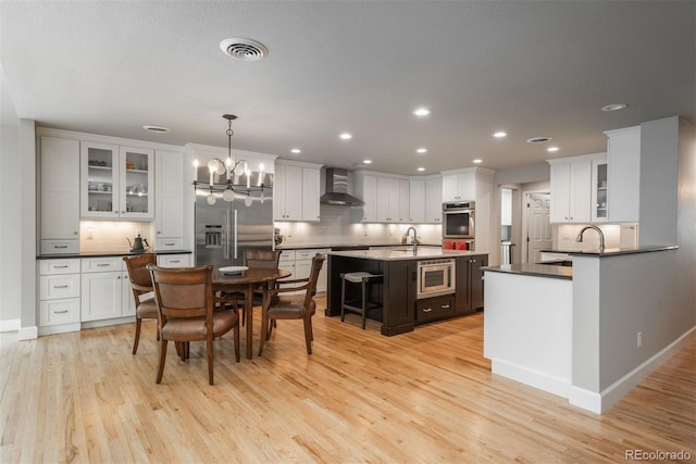5164 E Princeton Ave, Cherry Hills Village, CO 80113 - dining area with an inviting chandelier, recessed lighting, light wood-style flooring, and visible vents