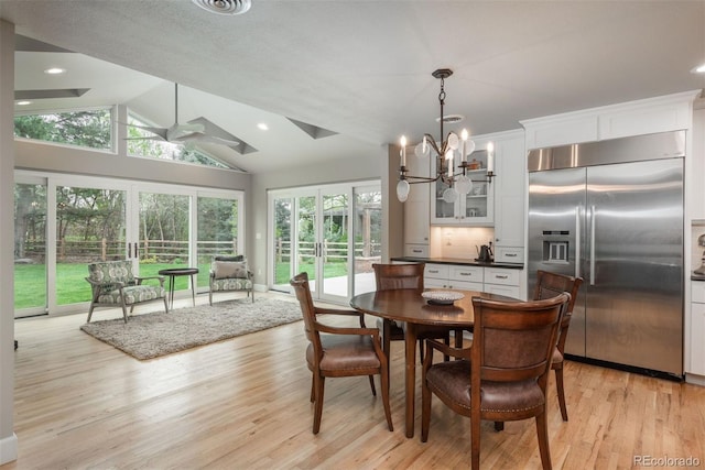 5164 E Princeton Ave, Cherry Hills Village, CO 80113 - dining room featuring ceiling fan with notable chandelier, vaulted ceiling, recessed lighting, and light wood-style flooring