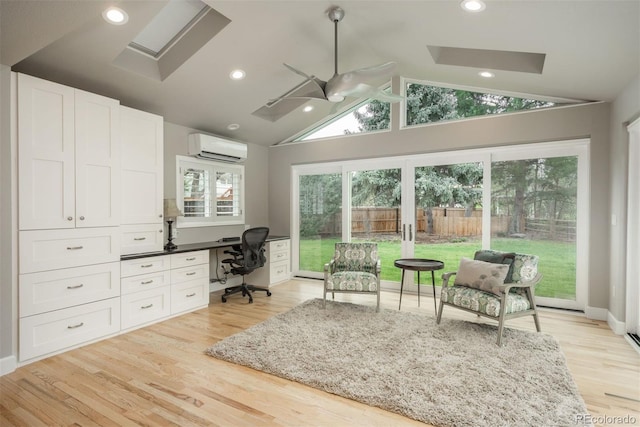 5164 E Princeton Ave, Cherry Hills Village, CO 80113 - office space with built in desk, light wood finished floors, vaulted ceiling with skylight, a wall mounted air conditioner, and a ceiling fan
