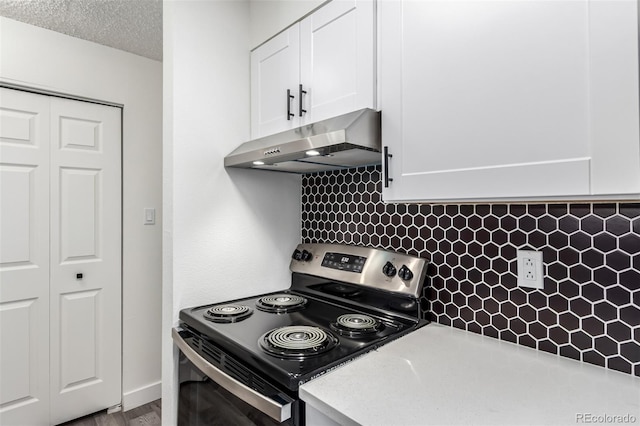 kitchen with tasteful backsplash, white cabinetry, a textured ceiling, and electric stove