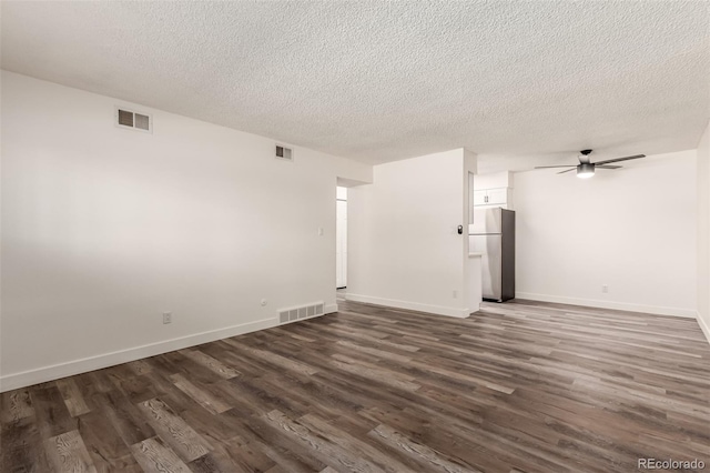 unfurnished room featuring a textured ceiling, dark wood-type flooring, and ceiling fan