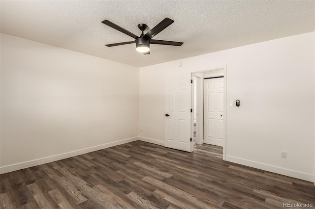 unfurnished room with ceiling fan, dark hardwood / wood-style floors, and a textured ceiling