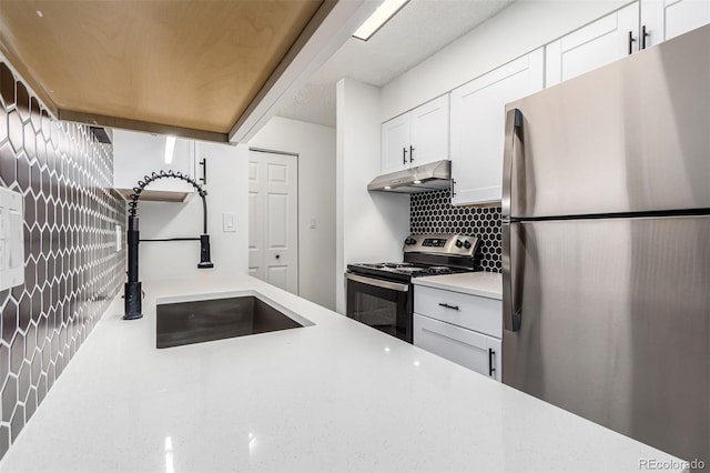 kitchen with white cabinetry, appliances with stainless steel finishes, sink, and backsplash