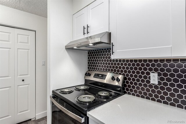 kitchen with electric stove, white cabinetry, tasteful backsplash, and a textured ceiling