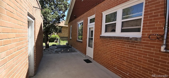 view of side of property featuring brick siding