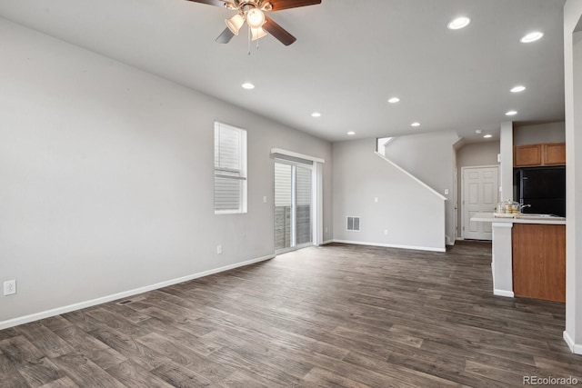 unfurnished living room with visible vents, baseboards, recessed lighting, a ceiling fan, and dark wood finished floors