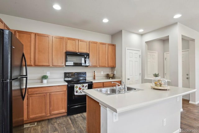 kitchen with dark wood-style flooring, visible vents, a sink, light countertops, and black appliances