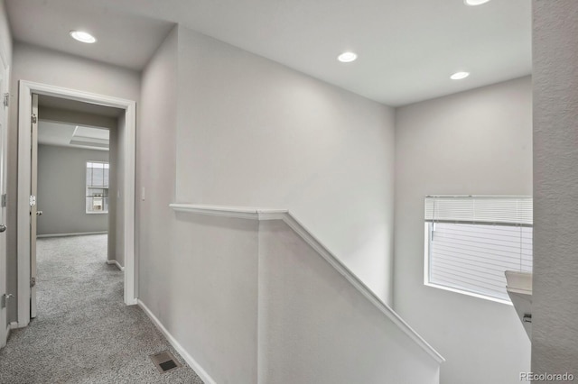corridor with visible vents, carpet, recessed lighting, and an upstairs landing