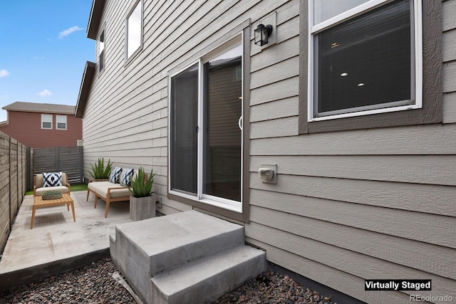 view of patio with fence and an outdoor hangout area