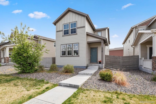 view of front of home featuring board and batten siding and fence
