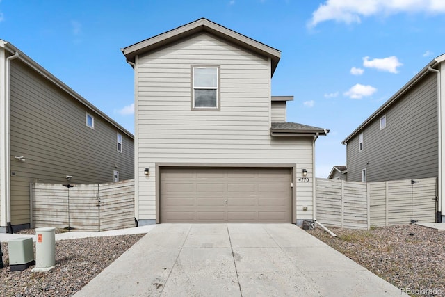 4770 N Jasper St, Denver, CO 80239 - view of front of property with a garage, fence, and concrete driveway