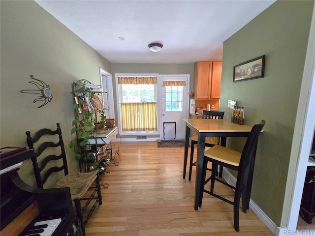 1245 S Forest St, Denver, CO 80246 - dining space featuring light wood-style flooring and baseboards