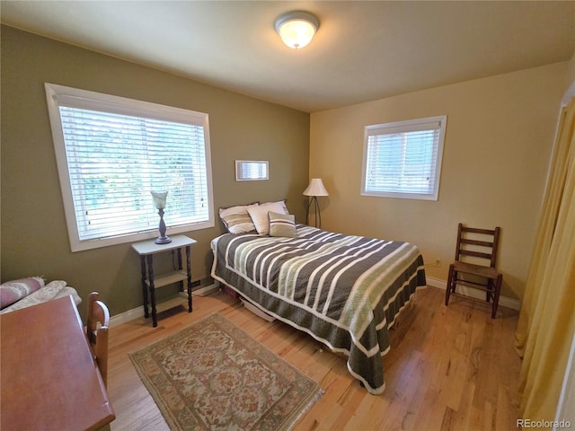 1245 S Forest St, Denver, CO 80246 - bedroom with light wood-type flooring and baseboards