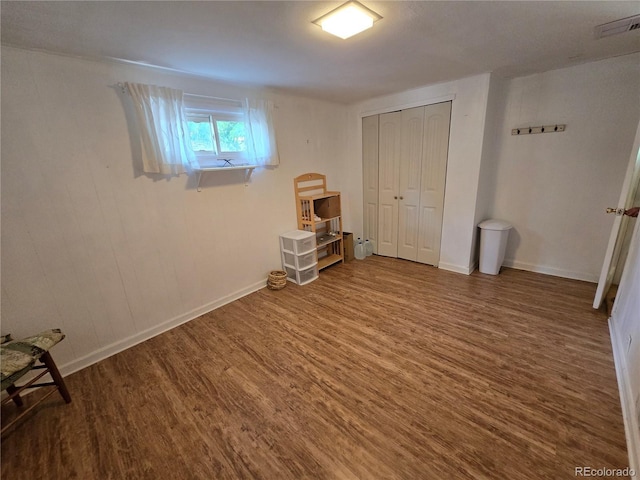 1245 S Forest St, Denver, CO 80246 - unfurnished bedroom featuring wood finished floors and a closet