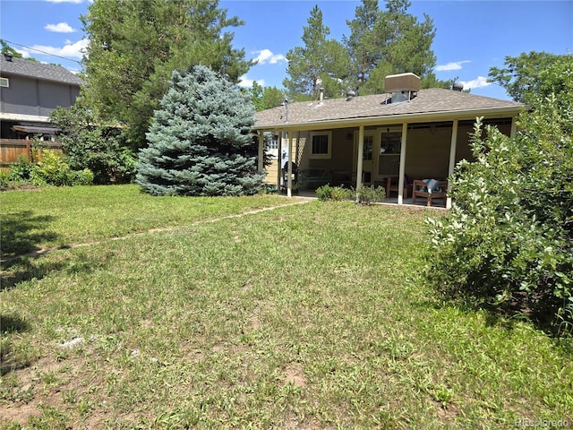 1245 S Forest St, Denver, CO 80246 - back of property with a patio and a lawn