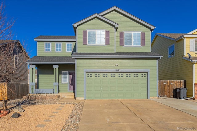 1895 Sage Grouse Ln, Colorado Springs, CO 80951 - view of front of property featuring a garage, fence, driveway, and a porch