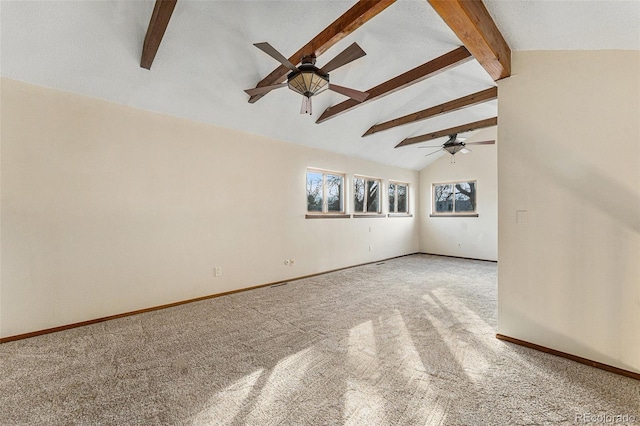 unfurnished living room with ceiling fan, lofted ceiling with beams, and carpet flooring