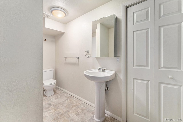 bathroom with toilet and sink